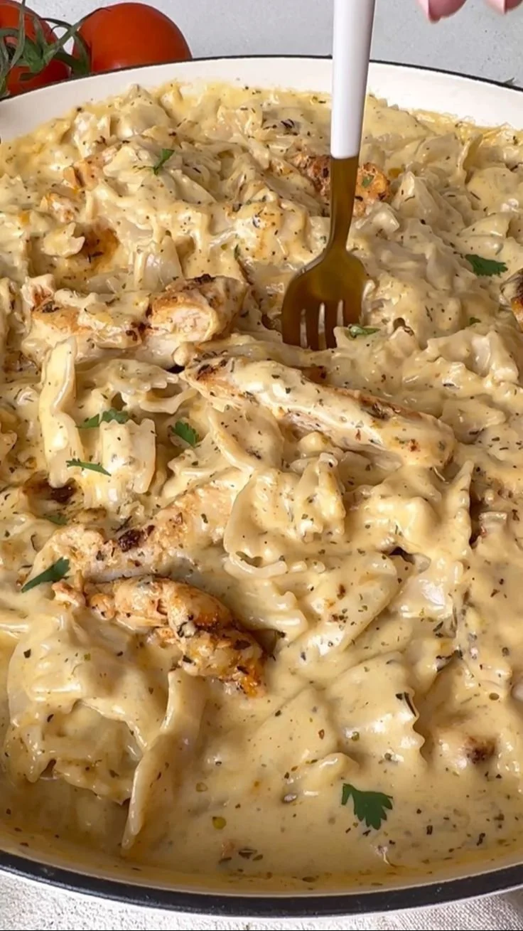 Delicious dairy free chicken alfredo served in a bowl with herbs