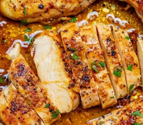 Skillet Garlic Butter Chicken served with herbs and spices