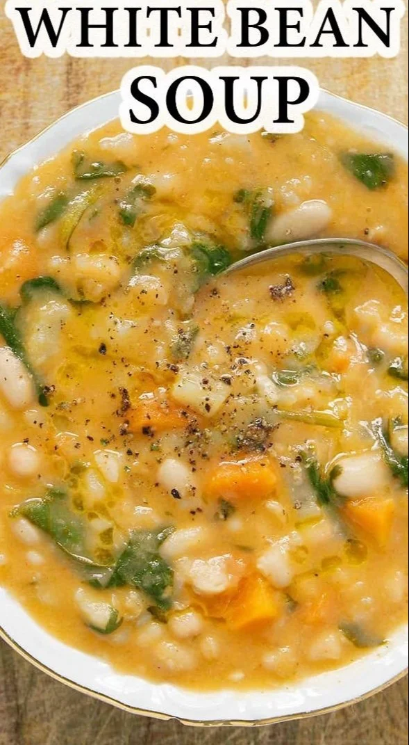 Bowl of homemade white bean soup garnished with herbs and spices