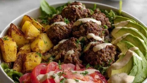 High protein burger bowl with fresh ingredients and colorful toppings.