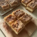 Delicious Churro Cheesecake Bars topped with cinnamon and sugar