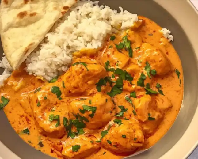 Delicious homemade butter chicken served with rice and naan.
