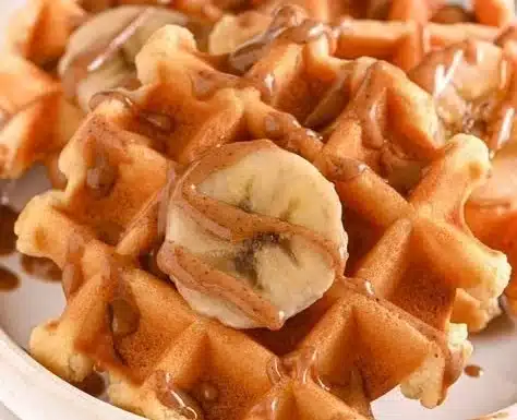 Delicious protein waffles topped with fresh berries and maple syrup