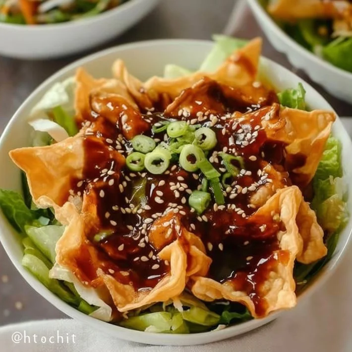 Teriyaki chicken wonton taco bowls garnished with fresh vegetables and sauce