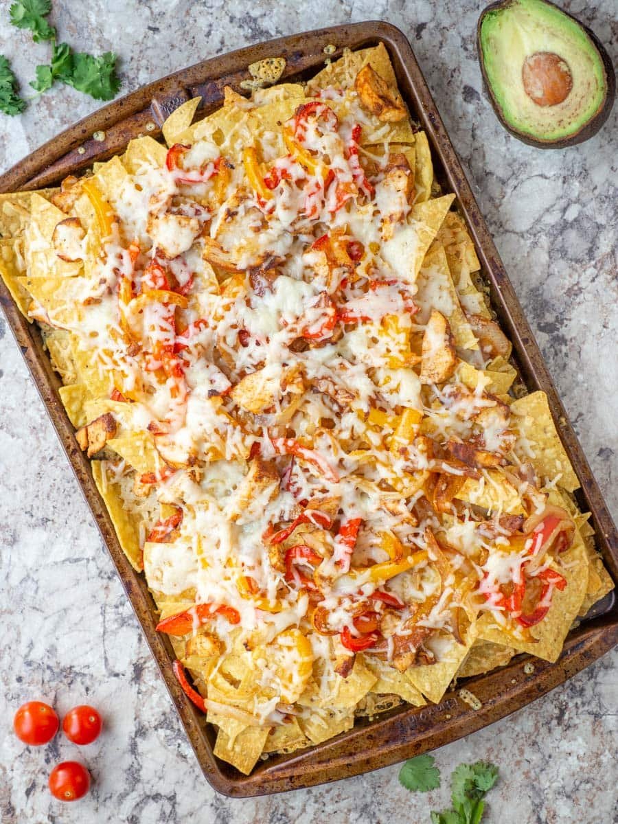 Delicious Chicken Fajita Nachos topped with chicken, peppers, and cheese