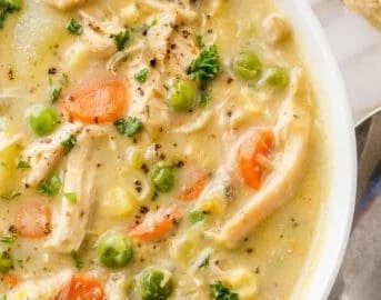 Bowl of delicious Chicken Pot Pie Soup with vegetables and flaky crust