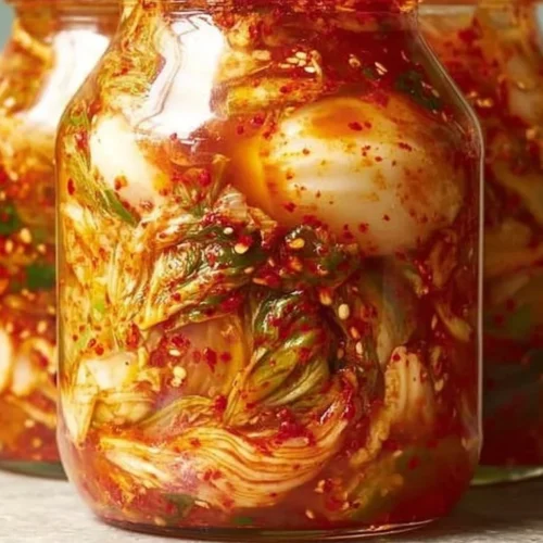 A bowl of homemade kimchi made with fresh vegetables and spices.