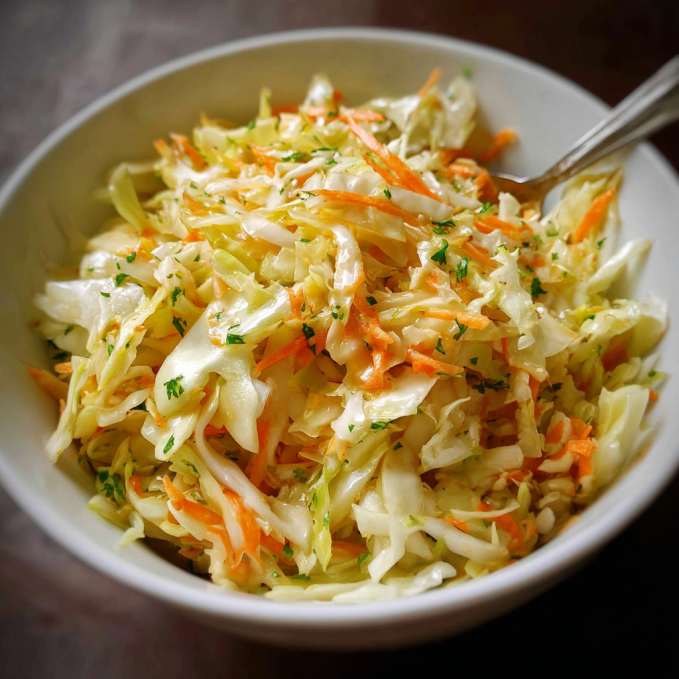 A bowl of tangy vinegar coleslaw with colorful cabbage and carrots
