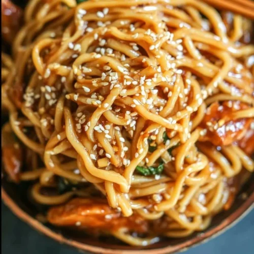 Delicious teriyaki chicken noodle bowl topped with fresh vegetables