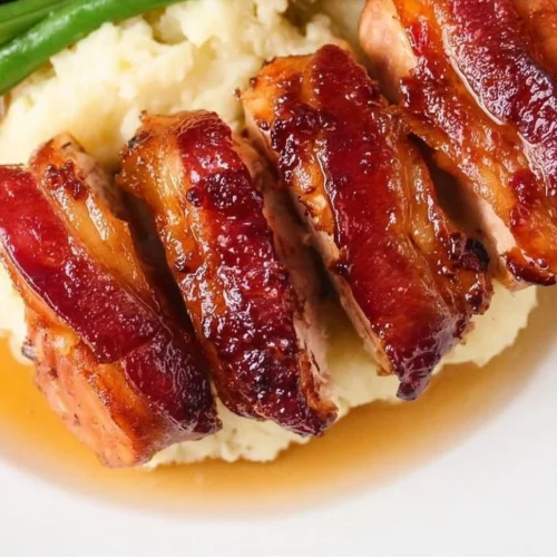 Plate of delicious bacon wrapped chicken ready to serve