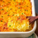 Cheesy hash brown casserole baked to golden perfection with cheese and crispy edges.