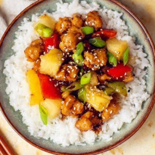 Delicious teriyaki chicken served in a pineapple bowl with fresh veggies.