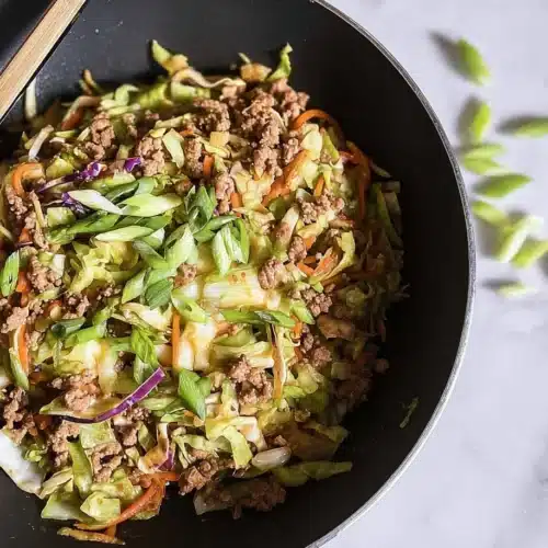 High protein egg roll in a bowl with fresh vegetables and savory sauce