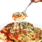 Oven Baked Chicken Parmesan topped with melted cheese and marinara sauce