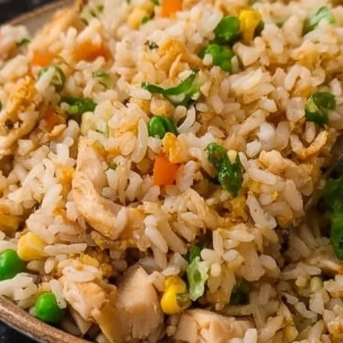 Bowl of simple fried rice with rotisserie chicken and vegetables
