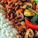Spicy ground beef stir fry bowl with garlic veggies and rice