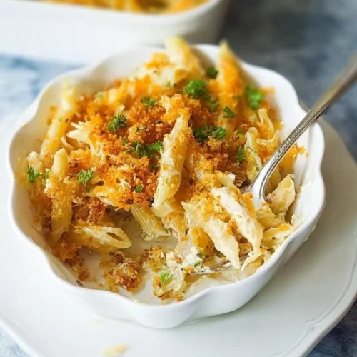 Creamy Tuna Noodle Casserole topped with breadcrumbs and peas